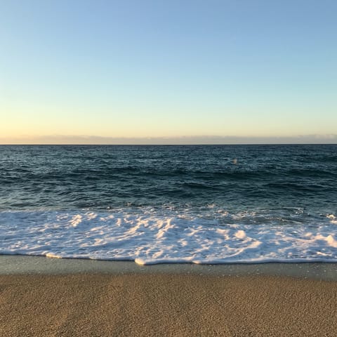 Slip on your sandals and stroll down to Elia Beach