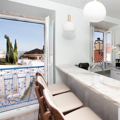 Admire the beautiful view of the Tagus River  from the breakfast bar