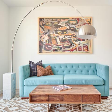 Lounge on the powder blue sofa with your favourite cocktail in hand