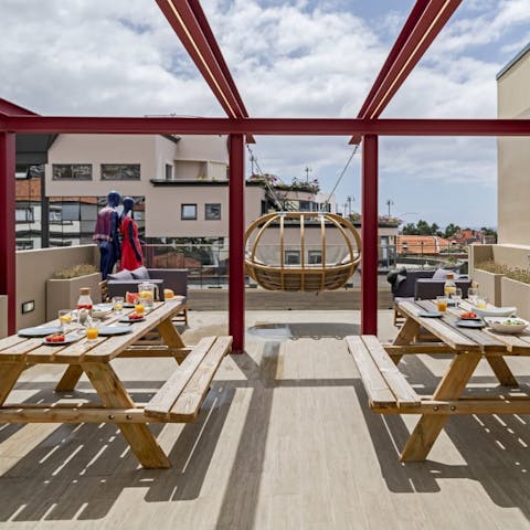 Head up to the communal roof terrace to enjoy alfresco meals and city views 