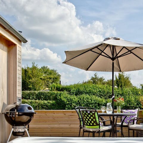 Grill up something fresh on the barbecue and dine alfresco beneath the parasol