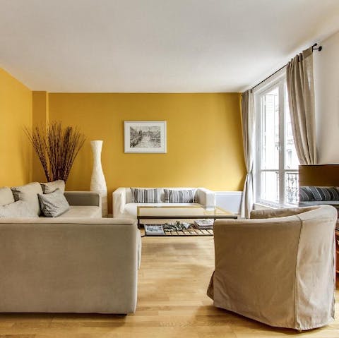 kick back in the sunshine yellow living room with a glass of wine after a day of Paris sightseeing