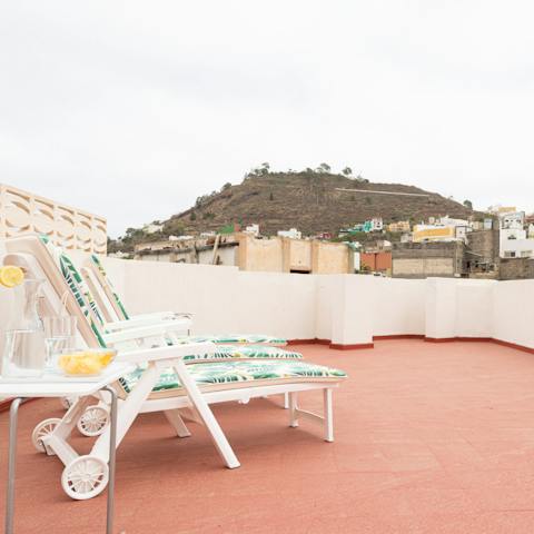Relax on the padded loungers on your rooftop terrace, while you take in views of the mountains