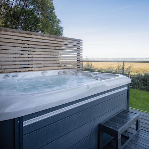 Relax in the hot tub with a glass of fizz and take in the Gower countryside views
