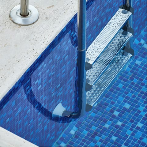 Cool down with a dip in the mosaic tiled infinity pool
