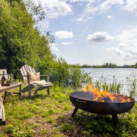 Gather for sundowners  by the lakeside fire pit