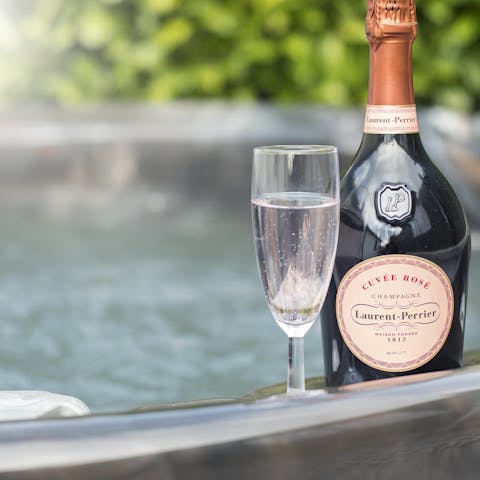 Indulge in a long soak in the outdoor hot tub, glass of prosecco in hand