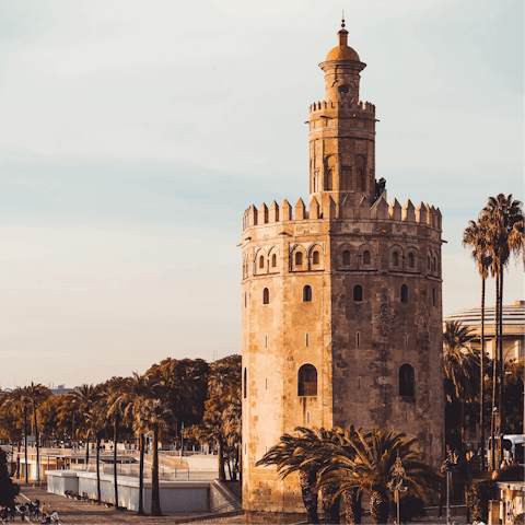 Stroll along the Guadalquivir River before visiting the  Torre del Oro