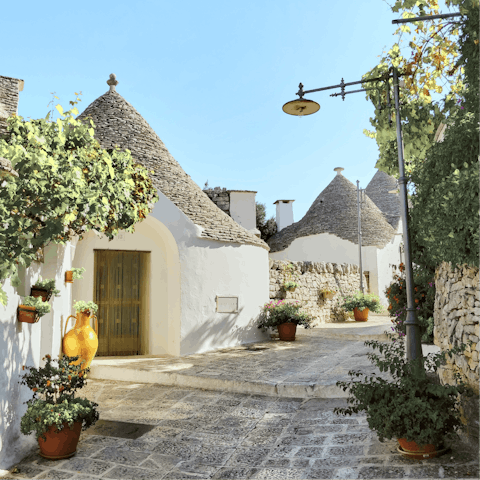 Visit the iconic cone-roofed houses of Alberobello, a short drive away