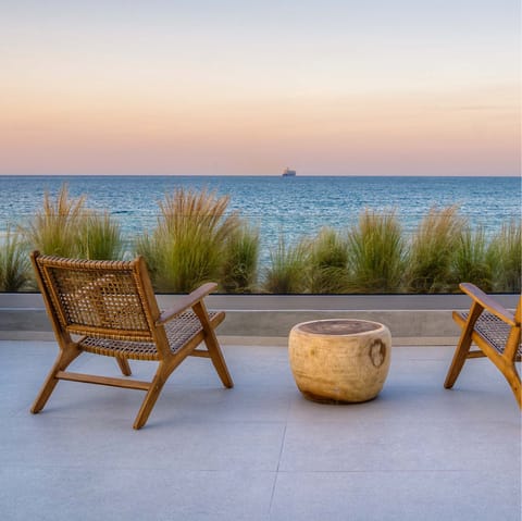 Watch the sunset over the blue Aegean Sea from your private terrace