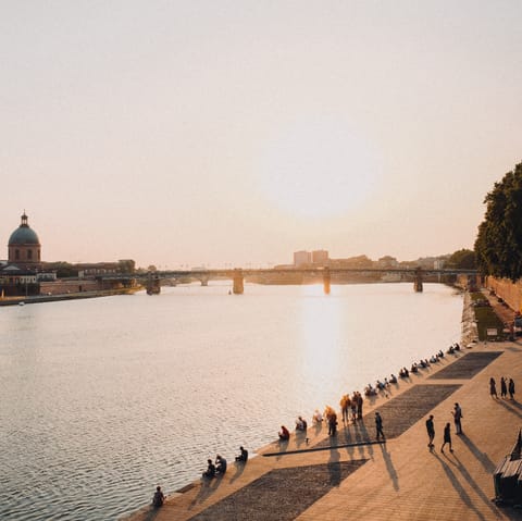 Enjoy a sunset stroll along the Garonne River, a short walk from your building