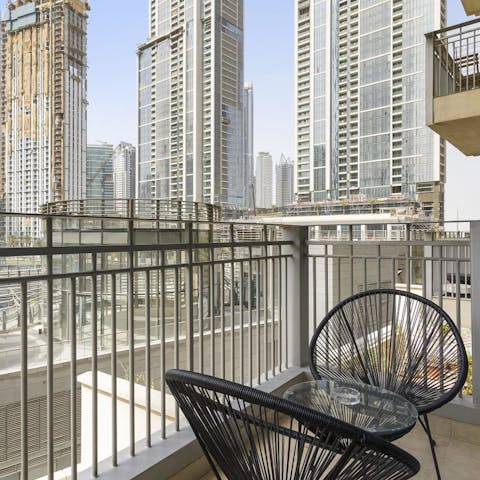Sip a refreshing drink on the balcony overlooking the cityscape
