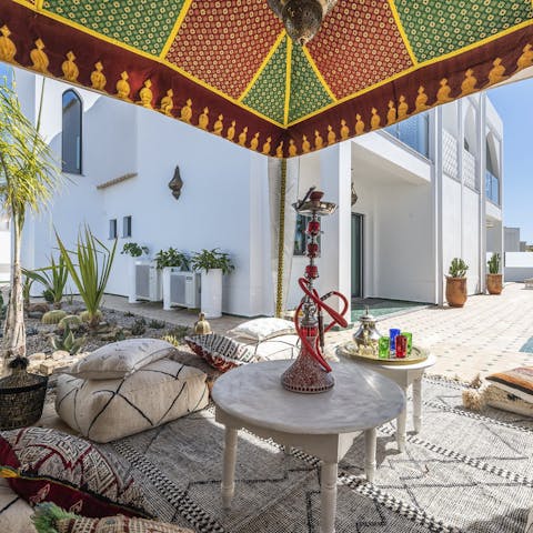 Gather with friends around the Moroccan-style outdoor lounge