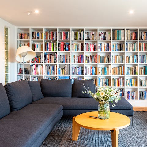 Pick a book off the shelf and curl up on the vast corner sofa