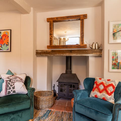 Curl up with a book on the comfy armchair by the traditional fireplace