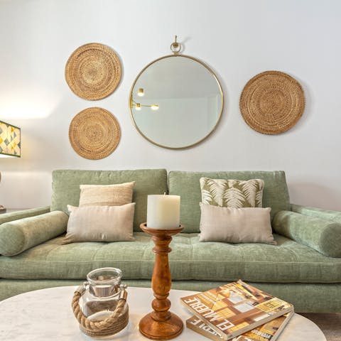 Relax on the sage green sofa with a glass of Spanish wine after a busy day of exploring