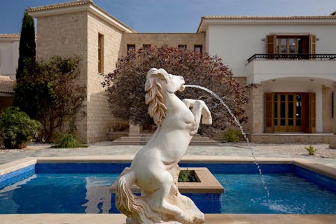 Admire the traditional Grecian design features, like the grand marble fountain