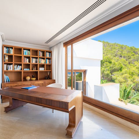 Set yourself up in the study, with a library of books and a desk for remote work against breathtaking views