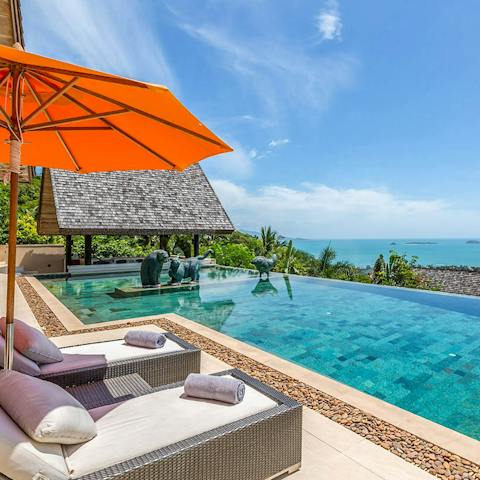 Relax by the glistening pool, with breathtaking views before you 
