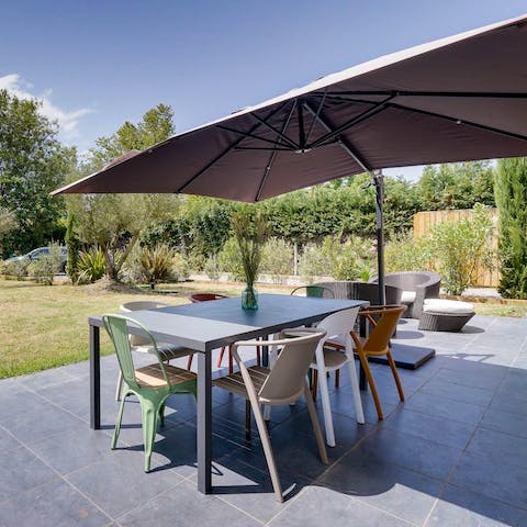 Sip on Bordeaux wine around the dining setup on your shaded terrace