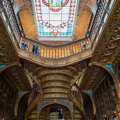 Browse the books at the beautiful Livraria Lello, an eleven-minute stroll away