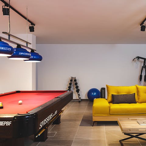 Shoot some pool and hang out in the basement games room