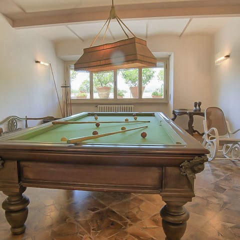 Chalk up and shoot some pool in the dedicated billiard room