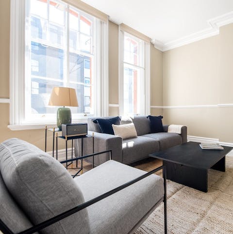 Kick back in the living room, flooded with natural light