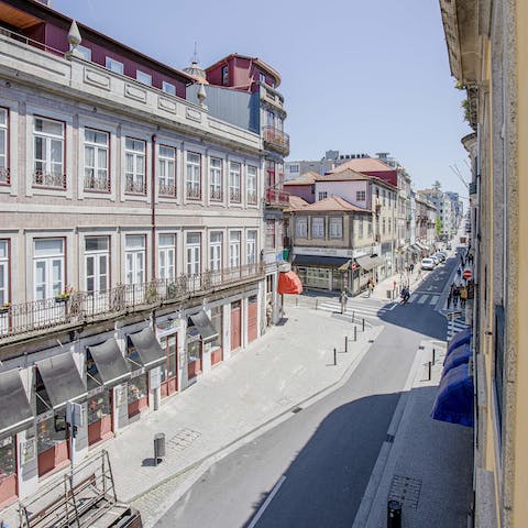 Perch by the living area's Juliet balconies with a glass of wine while taking in scenic street views