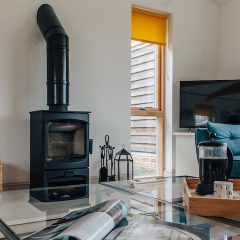Cosy up by the log burner fire with a cup of coffee in hand after a country walk along the riverbank – just two minutes away  