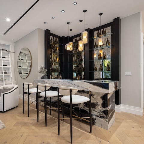 Serve drinks to your group from the stunning marble wet bar