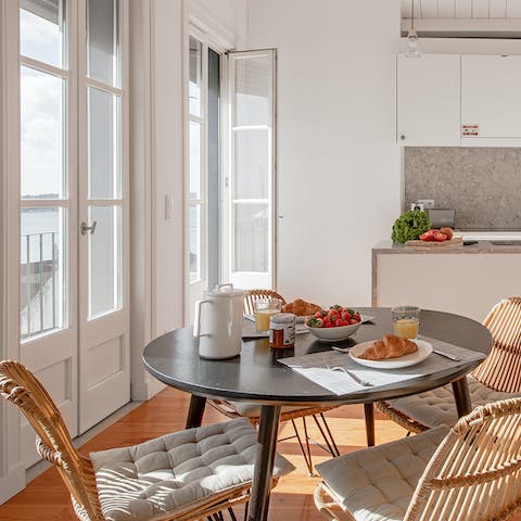 Enjoy breakfast at the bright dining table with the French doors thrown open