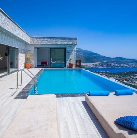 Relax by the pool and take in the stunning sea and mountain views 