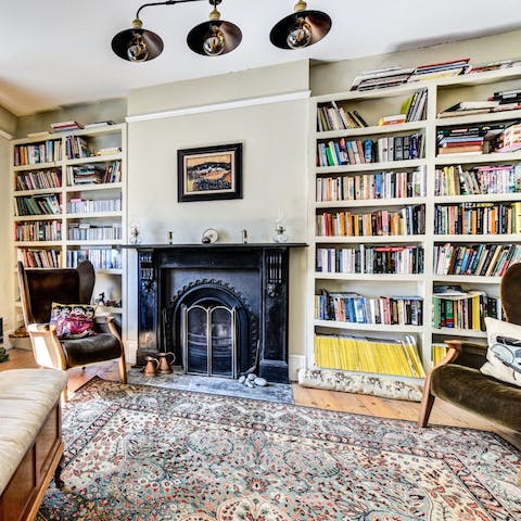 Lose yourself in a good book by the welcoming fireplace