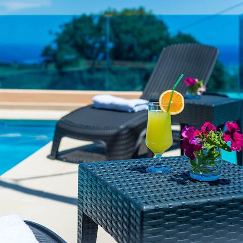 Make yourself a refreshing drink and relax on a sun lounger