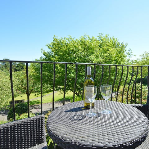 Enjoy a glass of wine on the first floor balcony overlooking the grounds