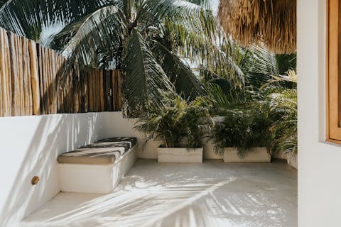 Relax under the shade of the palm trees on your private patio
