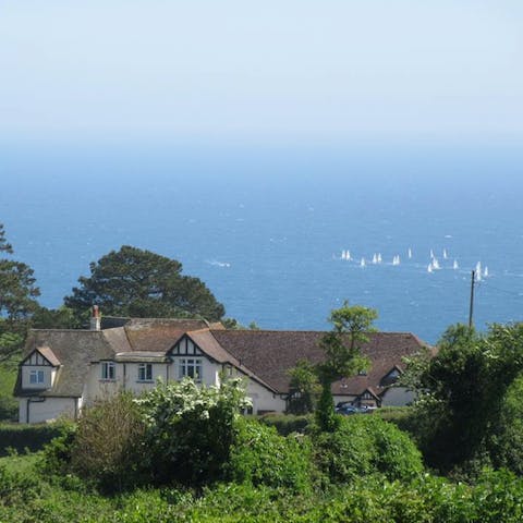 Relax in the expansive garden and gaze out at the stunning sea views