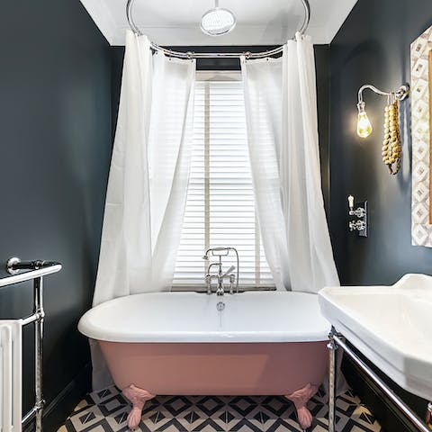 Soak off the day in this pretty in pink bathtub