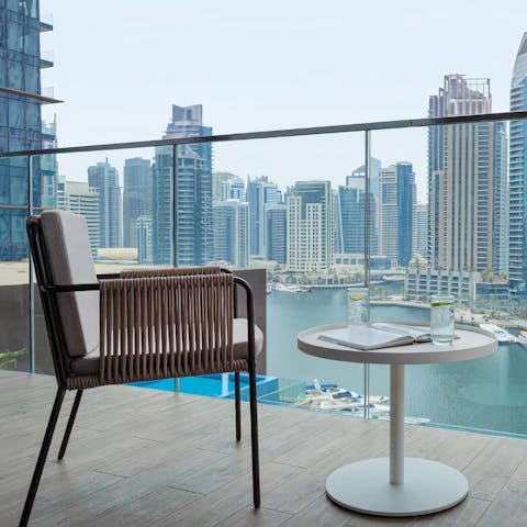 Enjoy your morning coffee on your balcony, overlooking the iconic marina