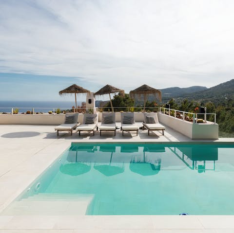 Admire the beautiful views from the pool or shaded sun loungers