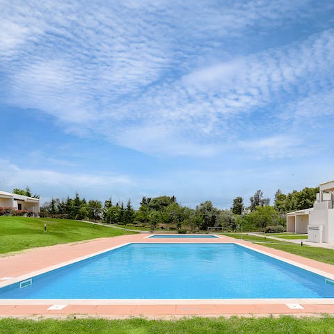 Swim in the communal pool as the sun warms your skin