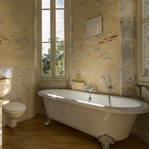 Have a luxurious soak in the roll-top bath after a long walk through this chateau's meadows and orchards