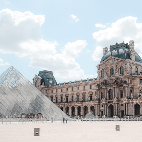 Spend an afternoon exploring the Louvre Museum, a short walk away