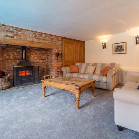 Curl up on the sofa next to inglenook fireplace and log burner