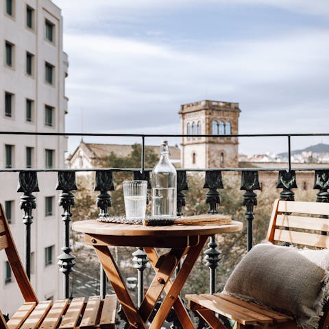 Enjoy a glass of Spanish wine on the private balcony at the end of a busy day