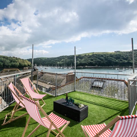 Sunbathe on the balcony and take in the stunning views of the water