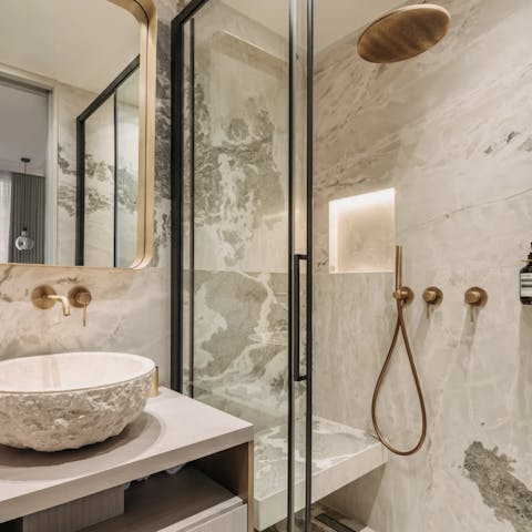 Begin your mornings under rainfall showers in the marble en-suite bathrooms
