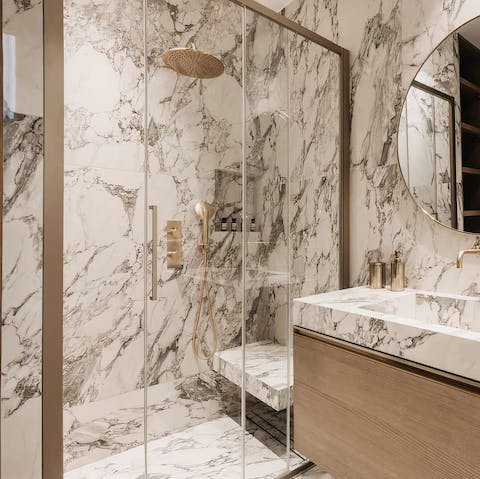 Feel anew beneath the marble-clad rainfall shower