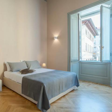 Wake up to Piazza Guido Grimoldi views in the main bedroom